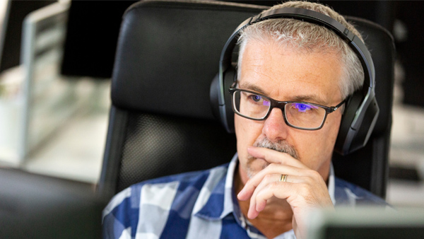 Guy with headphones at desk